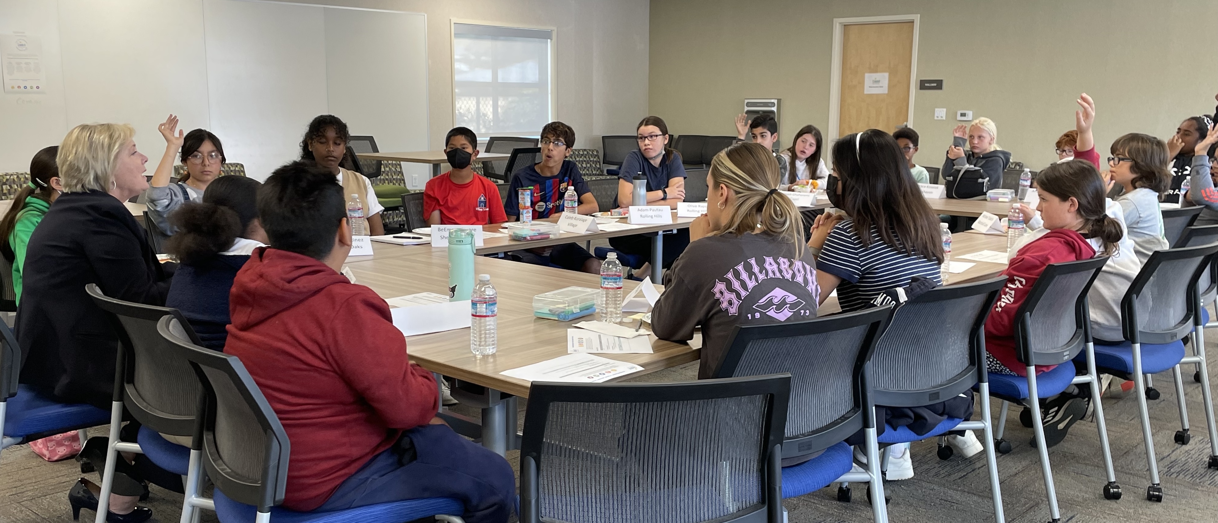 20 students sit at a meeting table with Superintendent Viramontez